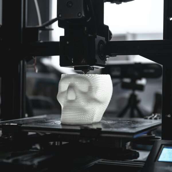 The 3D printer prints white plastic model