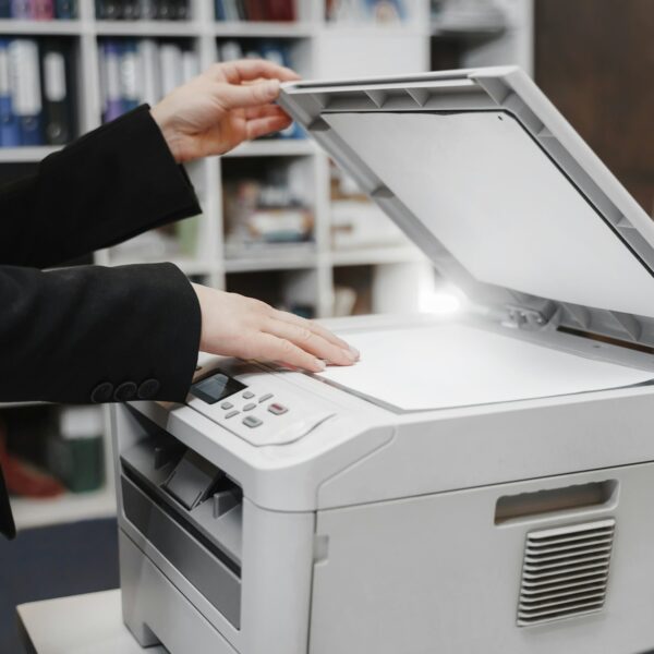 Woman's hand with working copier scanner printer